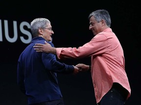 Apple's senior vice-president of Internet Software and Services Eddy Cue (R) greets Apple CEO Tim Cook (L) during the Apple WWDC on June 8, 2015 in San Francisco.  (Justin Sullivan/Getty Images/AFP)