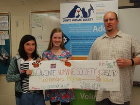 Tyendinaga Public School Grade 6 students Aurora Sheppard and Sarah Morris present Quinte Humane Society executive director Frank Rockett with a cheque Thursday to support a cat cage. 
Jessica Laws/For The Intelligencer