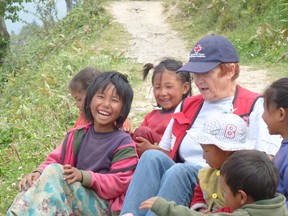 Disaster relief worker Bonnie Kearns visits with children at the Red Cross base camp in Dhunche, Nepal. The retired Sarnia nurse just returned from the earthquake-ravaged country after spending a month assisting the injured and ill through the Canadian Red Cross. 
(Handout/Sarnia Observer/Postmedia Network)