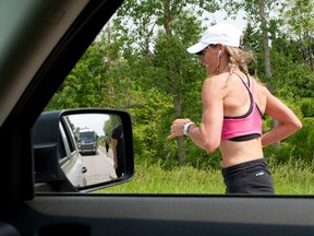 Breast cancer survivor Theresa Carriere runs down Hickory Drive near Strathroy during her OneRun fundraiser. (Free Press file photo)