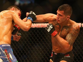 Rafael dos Anjos fights with Anthony Pettis in the Lightweight Title bout during the UFC 185 event at American Airlines Center on March 14, 2015 in Dallas, Texas.  (Ronald Martinez/AFP)