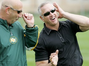 Matt Dunigan, shown here in 2009 with former Eskimos receivers coach Mike Kelly, stopped by Esks camp in Spruce Grove Thursday on his way up to Fort McMurray to work on the broadcast of Saturday's preseason game against the Roughriders. (Edmonton Sun file)