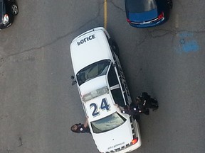 Gatineau police arrest a man on Dalhousie St. in Ottawa in this image taken by a witness from his balcony. (SUBMITTED)