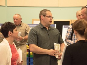 Ward 6 Coun. Rene Lapierre speaks with a group of concerned citizens at Thursday’s public session, which was hosted by SkyPower Global to share information about four proposed solar farms. (Mary Katherine Keown/The Sudbury Star)
