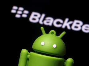 An Android mascot is seen in front of a logo of Blackberry in this photo illustration taken in Zenica, Bosnia and Herzegovina, June 12, 2015. REUTERS/Dado Ruvic