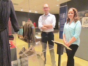 Laurie Webb, right, curator-supervisor of the Lambton County Museums, and assistant curator Luke Stempien are shown on Wednesday June 10, 2015 in Lambton Shores, Ont., at the Lambton Heritage Museum's new exhibit, Lambton at War. Paul Morden/Sarnia Observer/Postmedia Network