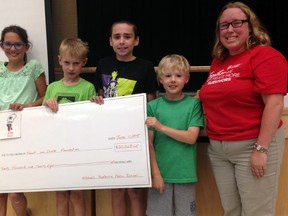 Mitchell Hepburn Public School's top Jump Rope for Heart fundraisers present a $20,028 cheque to the Heart and Stroke Foundation at a school assembly Thursday. The school chose to donate another $400 each to Nepal earthquake relief and local athlete Noah Rolph who is attempting to raise money to compete in a national track and field competition this summer.
