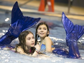 Kids in mermaid tails play in a pool. Reuters photo