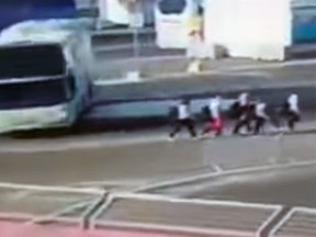 A screen capture from video footage showing Austrian swimmers getting hit by a shuttle bus in Baku, Azerbaijan. (YouTube)
