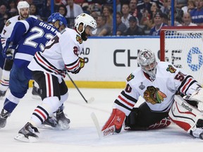 Blackhawks goalie Corey Crawford (right) and defenceman Johnny Oduya (27) try to clear the puck away from Lightning right wing J.T. Brown (23) during Game 2 of the Stanley Cup final in Tampa, Fla., on June 6, 2015. (Kim Klement/USA TODAY Sports)