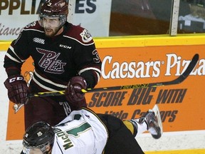 Peterborough Petes' Cameron Lizotte upends London Knights' Owen MacDonald during OHL action earlier this season. Many expect Lizotte to be a pick in the upcoming NHL Entry Draft. Clifford Skarstedt/Peterborough Examiner/Postmedia Network