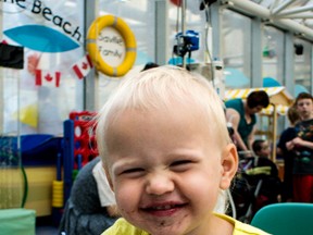 Natalie Aalders smiles as she enjoys a Dairy Queen Blizzard at the beach in the Stollery Children’s Hospital in Edmonton on Wednesday August 13th. Photo Supplied/Stollery Kids