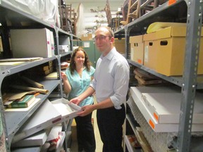 Laurie Webb, curator-supervisor with the Lambton County museums, and assistant curator Luke Stempien are shown in a crowded storage room at the museum on Wednesday June 10, 2015 in Lambton Shores, Ont. The museum is launching a storage re-organization project this year. (Paul Morden, The Observer)