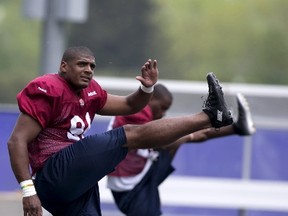 Michael Sam (L), newly signed defensive end for the Montreal Alouettes CFL football team stretches during rookie training camp in Sherbrooke, Quebec May 27, 2015.  REUTERS/Christinne Muschi