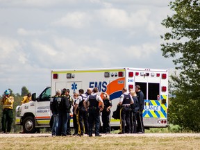 Alberta Forestry, RCMP and paramedics gather at the tanker base at Whitecourt's airport after the return of four Mounties that became stranded when their boat capsized in the Athabasca River on Friday June 12, 2015 northwest of Whitecourt, Alta.

Adam Dietrich/Whitecourt Star/Postmedia Network