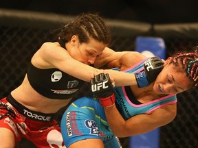 Joanna Jedrzejczyk (left) fights with Carla Esparza in the women’s strawweight bout during UFC 185 at American Airlines Center on March 14, 2015 in Dallas. (Ronald Martinez/Getty Images/AFP)