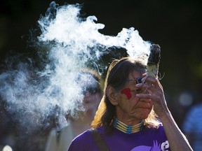 A First Nations holds a smudge stick while walking to honour residential school survivors in Vancouver, June 11, 2015. (REUTERS/Ben Nelms)