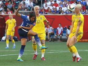 United States forward Cristen Press (left) has a blocked shot sail past Sweden defender Nilla Fischer during the FIFA Women's World Cup Canada 2015 in Winnipeg on Fri., June 12, 2015. Kevin King/Winnipeg Sun/Postmedia Network