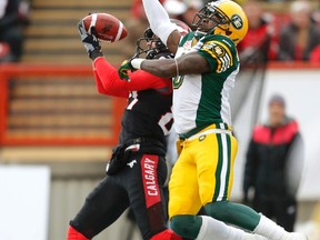 Calgary Stampeders Simon Charbonneau-Campeau reaches out to catch the ball against Edmonton Eskimos Alonzo Lawrence during the second quarter in the CFL Western Finals game at McMahon Stadium in Calgary, Alta. on Sunday November 23, 2014. Al Charest/Calgary Sun/QMI Agency