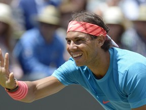 Spain's Rafael Nadal reacts as he and France's Gael Monfils warm up for their semifinal match at the ATP Mercedes Cup tennis tournament in Stuttgart, Germany, on June 13, 2015. (AFP PHOTO / THOMAS KIENZLE)