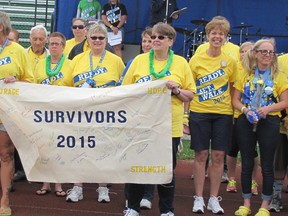 Cancer survivors get ready to take the first lap around the track in the Relay for Life in Chatham. (Blair Andrews/Chatham This Week)