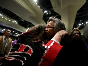 Reverend Lily Bell of the Haida Nation (left) hugs a friend during the closing ceremonies of the seventh and final Truth and Reconciliation Commission (TRC) event at the Shaw Conference Centre, in Edmonton Alta., on Sunday March 29, 2014. David Bloom/Edmonton Sun/QMI Agency