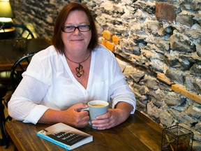 Author Gilaine Mitchell enjoys a cup of coffee at Sweet Escape Cafe on Friday June 12, 2015 in Belleville, Ont. The local author will be at Chapters on June 20 for a book signing of her novel, The Breaking Words. Tim Miller/The Intelligencer
