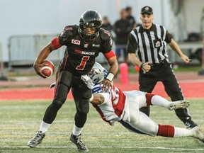 Montreal Alouettes' Chris Bakers tackles Ottawa Redblacks' Henry Burris during CFL action in Quebec City on Saturday June 13, 2015. Francis Vachon/Postmedia Network