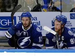 Cedric Paquette, left, and Steven Stamkos of the Tampa Bay Lightning look on from the bench as their team trails the Chicago Blackhawks in the third period in Game Five of the 2015 NHL Stanley Cup Final at Amalie Arena on June 13, 2015. (Mike Carlson/Getty Images/AFP)
