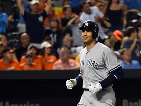 New York Yankees designated hitter Alex Rodriguez (13) reacts as he runs down the third base line after hitting a two run home run for RBI 2001 of his career during the sixth inning against the Baltimore Orioles at  Oriole Park at Camden Yards, June 13, 2015. (Tommy Gilligan-USA TODAY Sports)