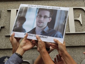 Protesters supporting Edward Snowden, a contractor at the National Security Agency (NSA), hold a photo of Snowden during a demonstration outside the U.S. Consulate in Hong Kong, in this June 13, 2013 file photo. (REUTERS/Bobby Yip/Files)
