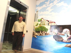 Dante Club president Myles Vanni poses with the Sarnia club's new elevator and mural where donor recognition plaques will hang. They're part of a recent $300,000 renovation Vanni says has made the club fully accessible. (Tyler Kula/Sarnia Observer/Postmedia Network)