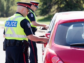 Members of the Edmonton Police Service do traffic enforcement near Saskatchewan Drive and University Avenue on May 14, 2015.  David Bloom/Edmonton Sun/Postmedia Network
