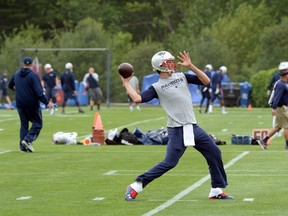 Tom Brady of the New England Patriots throws a ball during organized team activities at Gillette Stadium on June 4, 2015. (Darren McCollester/Getty Images/AFP)