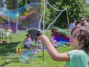Aislinn Aird plays with her sisters at the bubble station, one of many fun activities in City Park in Kingston, On Saturday June 13th  2015 celebrating local Pride. Kendra Pierroz  for The Whig-Standard, Postmedia Network
