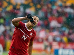 Team Canada's Melissa Tancredi takes a drink of water as she leaves the field after their game against New Zealand was delayed due to lightning during the FIFA Women's World Cup at Commonwealth Stadium on June 11, 2015. (David Bloom/Edmonton Sun/Postmedia Network)
