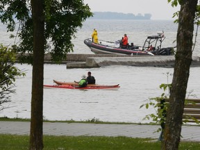 Members of  Toronto Police marine unit search near the mouth of the Humber River for a man who fell from a cruise ship. (STAN BEHAL, Toronto Sun)