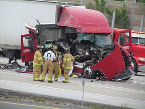 Several westbound lanes on Highway 402  were blocked by accident on Monday June 15, 2015 in Sarnia, Ont., near the Christina Street overpass. Emergency crews are shown here at approximately 9 a.m. (Paul Morden, Sarnia Observer)