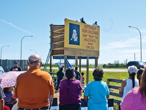 A crowd watches on as the new billboards north of Piikani on Highway 3 are unveiled. The signs were constructed and commissioned by the Piitaapoyi drug and alcohol awareness group. Greg Cowan photo/Pincher Crrek Echo.