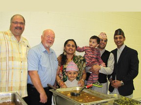 Nepalese families from Chatham and Loads of Love were pleased with the turnout for a fundraising lunch and auction held at the WISH Centre on June 14. The meal, featuring Nepalese dishes, raised donations to help earthquake victims in Nepal. From left: Kevin Broadwood and John Cornelius of Loads of Love; Rushil Burlakoti (front), Pragyan Burlakoti, Prerak Burlakoti, Rishi Burlakoti and Pratik Gautam. (Blair Andrews/Chatham This Week)