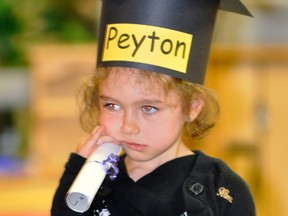 Peyton Ward seems a little disappointed, reluctant, or shy, in the fact that she was graduating from the largest ever pre-school graduating class of Perth Care for Kids last Friday, June 12. ANDY BADER/MITCHELL ADVOCATE