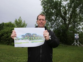 Martin Skolnick, vice-president of DTZ Eastern Ontario Limited, holds a drawing of Terre Verde, a new development planned for the intersection of Centennial and Cataraqui Woods drives in Kingston. (Elliot Ferguson/The Whig-Standard)