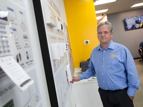 Owner Ian Schleihauf stands beside a display showing the security products for sale at IRS Security on Belmont Dr. at Wharncliffe. (CRAIG GLOVER, The London Free Press)