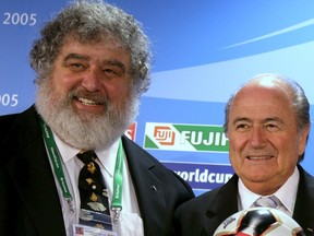 FIFA President Sepp Blatter, right, and FIFA Confederations Cup Chairman Chuck Blazer present the official match ball in Germany in this June 13, 2005 file photo. Blazer, a U.S. citizen, secretly pleaded guilty to 10 criminal counts in New York as part of an agreement with U.S. prosecutors, according to a partially blacked out transcript of the hearing released on June 3, 2015. (REUTERS/Kai Pfaffenbach/Files)