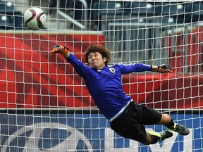 Japan's goalkeeper Miho Fukumoto leaps in the air to stop a ball during a training session at the Winnipeg Stadium before their Group C football match of the 2015 FIFA Women's World Cup against Ecuador in Winnipeg, Manitoba on June 14, 2015. AFP PHOTO/JEWEL SAMAD