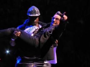 Torontonian Mark Baker on stage with Bono on June 12, 2015, during one of U2's Montreal dates of the band's Innocence + Experience tour. (Brett McMurrain photo)