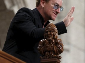 U2 lead singer Bono waves while being recognized in the House of Commons on Parliament Hill in Ottawa, Canada, June 15, 2015. REUTERS