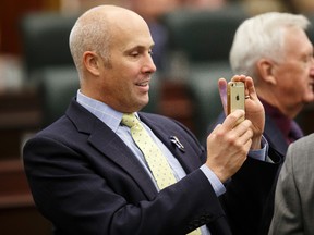 Alberta Party leader, and Calgary-Elbow MLA, Greg Clark takes a photo before the Speech From The Throne was read on the floor of the Alberta Legislature by Lt.-Gov. Lois Mitchell in Edmonton, Alta., on Monday June 15, 2015. The Speech From The Throne marks the beginning of the 29th Legislature. Ian Kucerak/Edmonton Sun/Postmedia Network