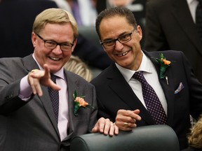 David Eggen (left), Minister of Education and Minister of Culture and Tourism, and President of Treasury Board and Minister of Finance Joe Ceci wave to a colleague before the Speech From The Throne was read on the floor of the Alberta Legislature by Lt.-Gov. Lois Mitchell in Edmonton, Alta., on Monday June 15, 2015. Ian Kucerak/Edmonton Sun/Postmedia Network
