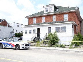 A Greater Sudbury Police Service officer guards a rooming house on Beech Street in Sudbury on Monday, June 15, 2015. A suspicous death occured at the building. Gino Donato/Sudbury Star/Postmedia Network